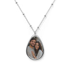 Couple's photo on a personalized teardrop pendant necklace on a silver beaded chain