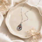 Close-up of a personalized couples photo pendant necklace