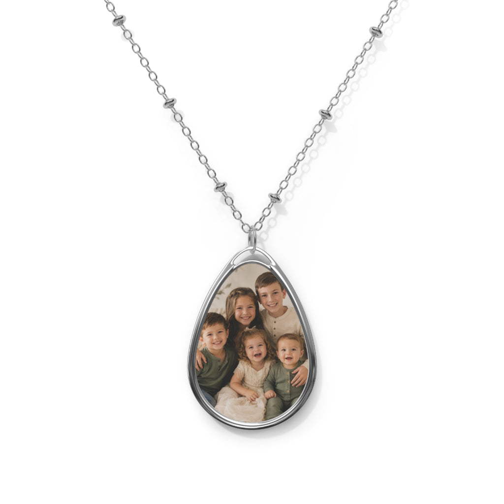 Children's photo on a personalized teardrop pendant necklace on a silver beaded chain