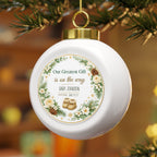 Baby announcement Christmas ornament hanging on a Christmas tree