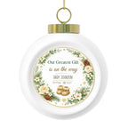 Personalized pregnancy announcement Christmas ornament with a greenery wreath, baby name, arrival date, and knitted booties