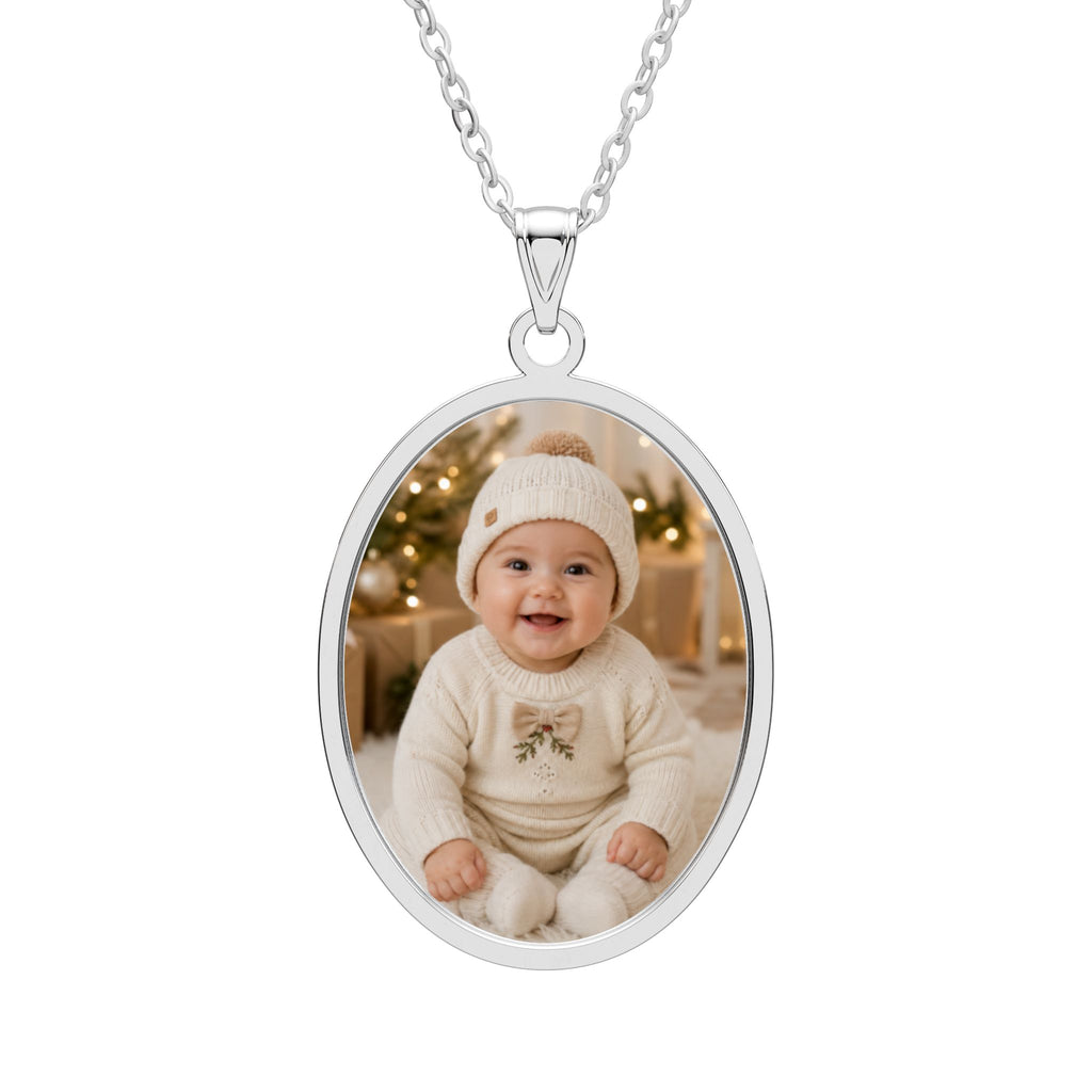 Personalized baby photo necklace in an oval sterling silver pendant with an engraved frame on a cable chain