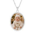 Personalized baby photo necklace in an oval sterling silver pendant with an engraved frame on a cable chain