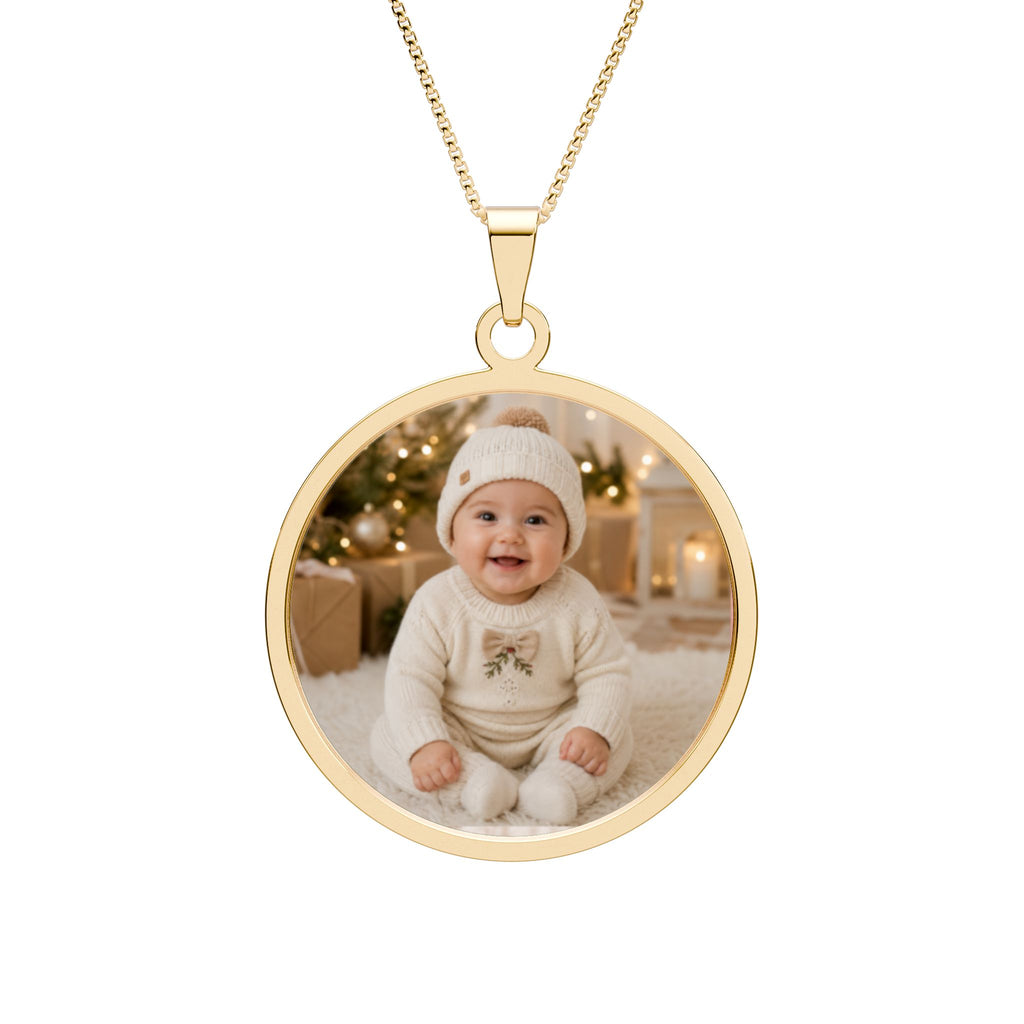 Personalized baby photo necklace in a gold-plated round pendant with an engraved border on a box chain