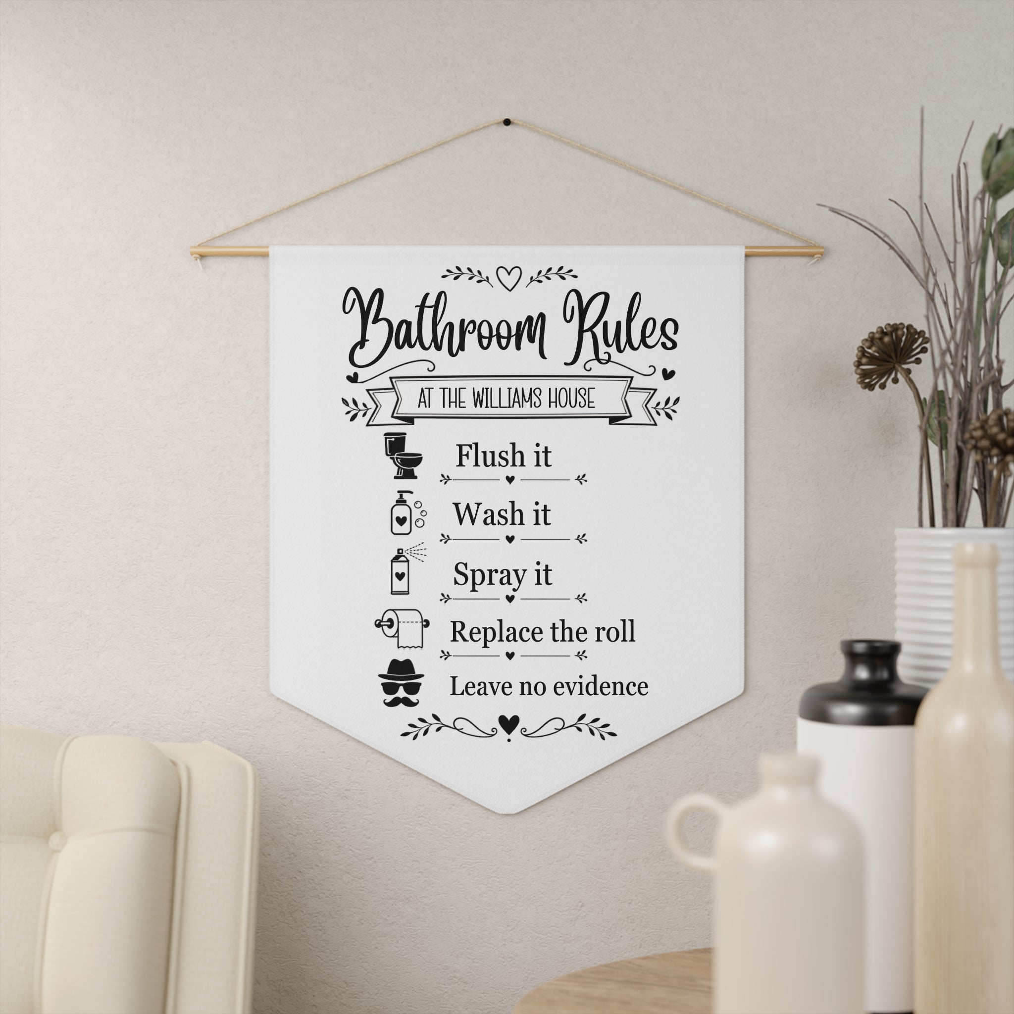 Bathroom Rules pennant shown hanging on a wall as funny bathroom decor
