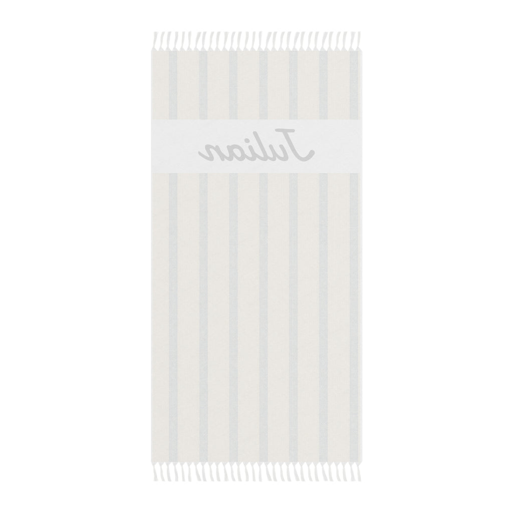 Personalized beige stripe beach towel laid flat with boho tassels
