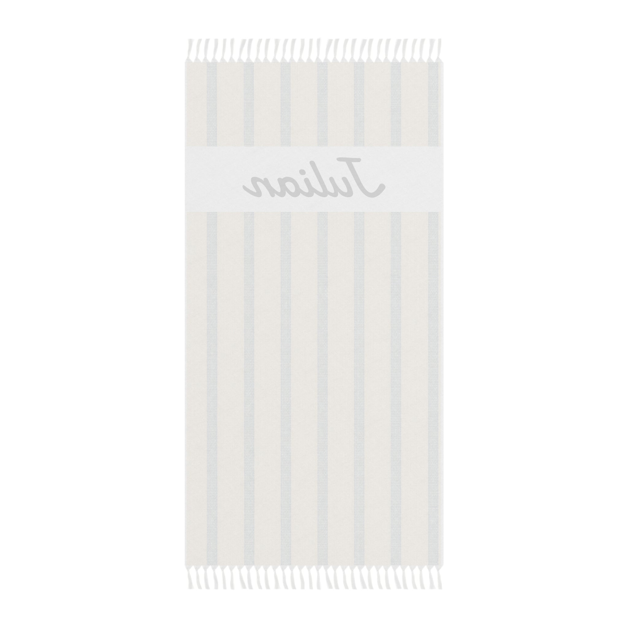 Personalized beige stripe beach towel laid flat with boho tassels