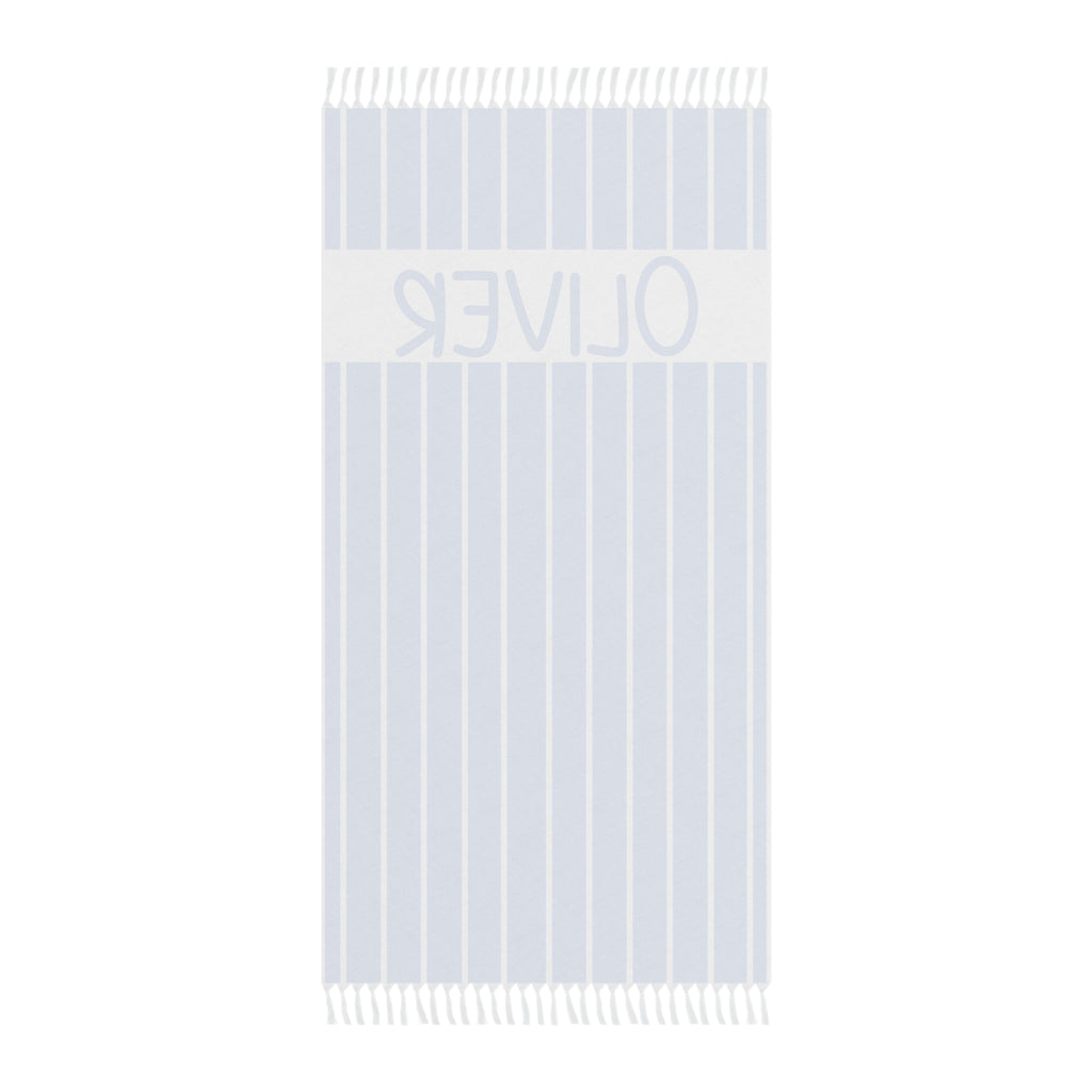 Personalized blue stripe beach towel laid flat with boho tassels