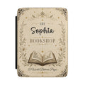 Personalized bookshop Kindle case in cream PU leather with an ornate floral border, an open book, and a custom name reading Bookshop