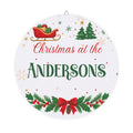 Personalized Christmas wood plaque with a family name, a red sleigh and holly garland on round birch