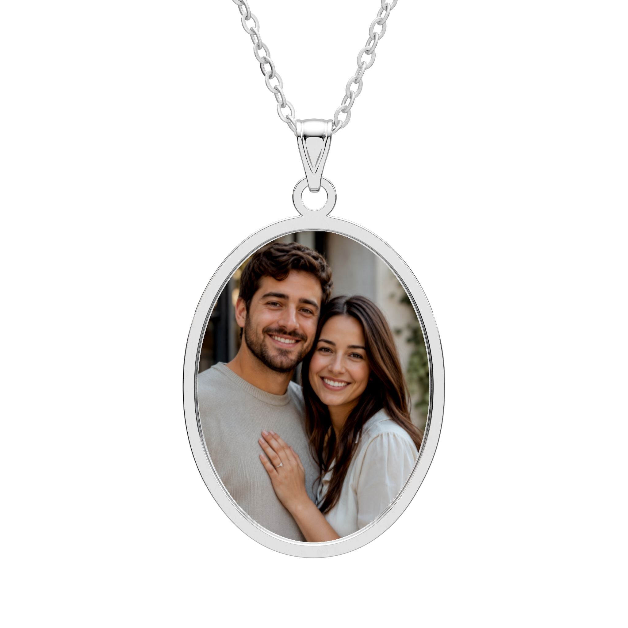 Personalized couple photo necklace in an oval sterling silver pendant with an engraved frame on a cable chain