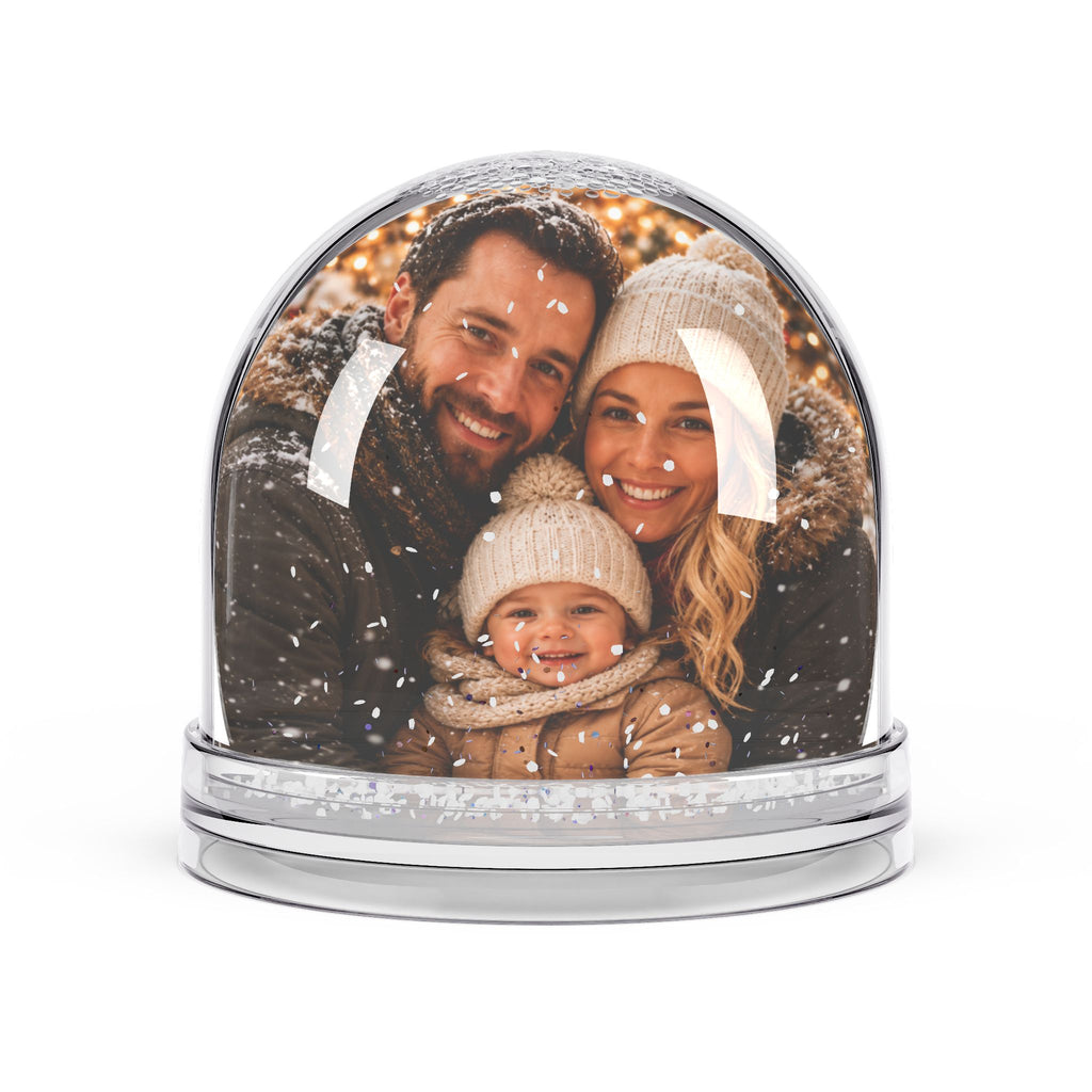 Personalized family photo snow globe with a winter portrait of parents and a child inside, swirling glitter snow over a clear polystyrene base