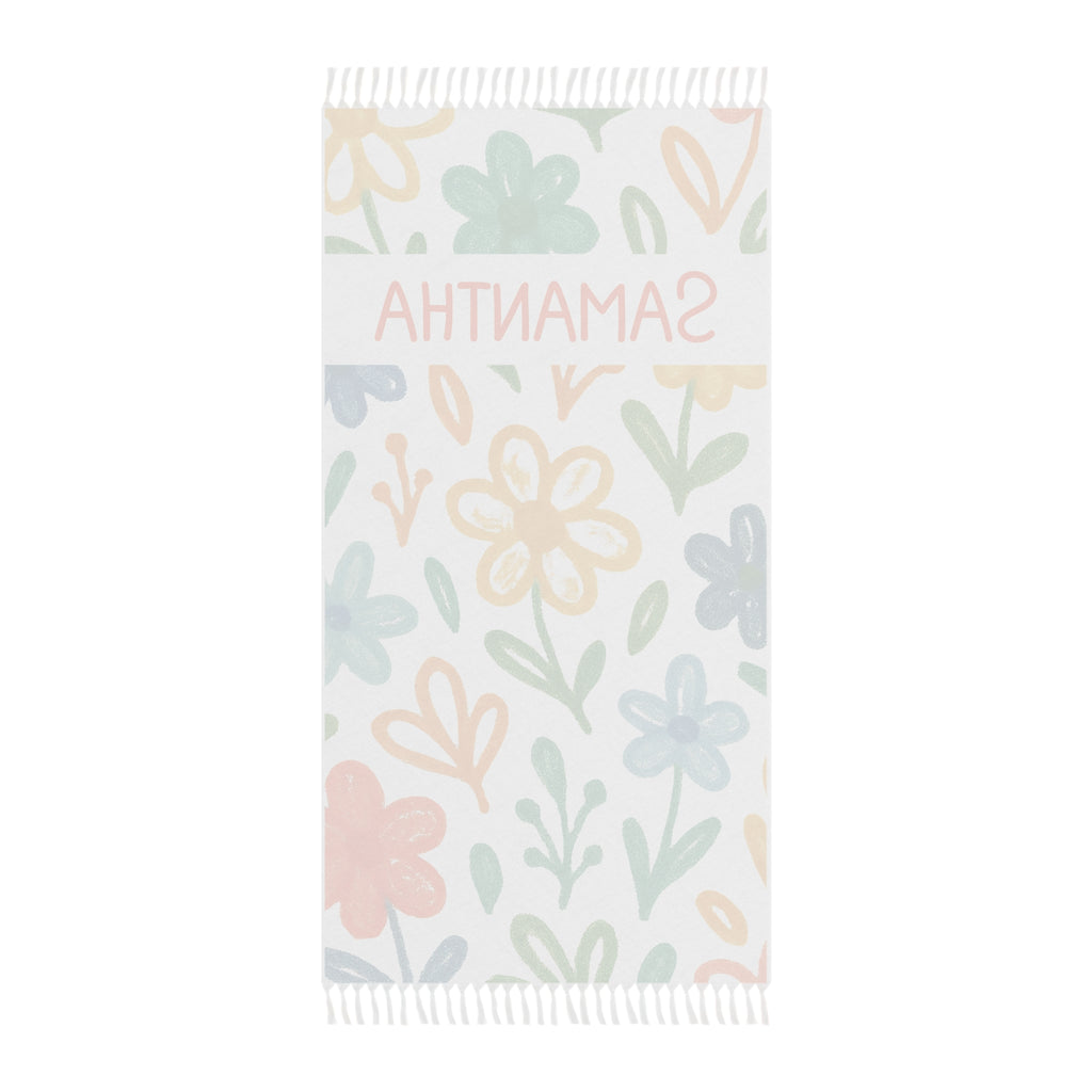 Personalized floral beach towel laid flat with boho tassels