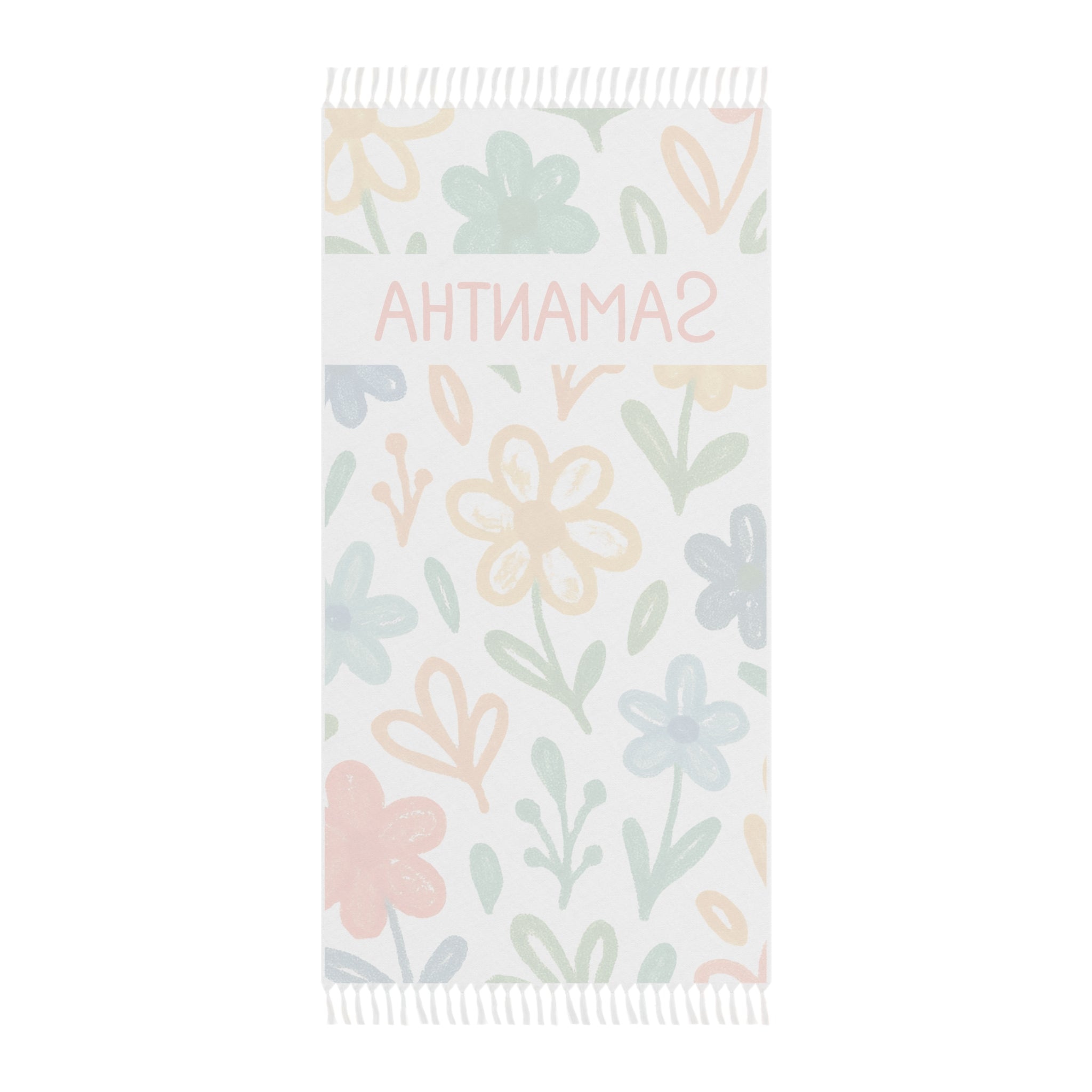 Personalized floral beach towel laid flat with boho tassels