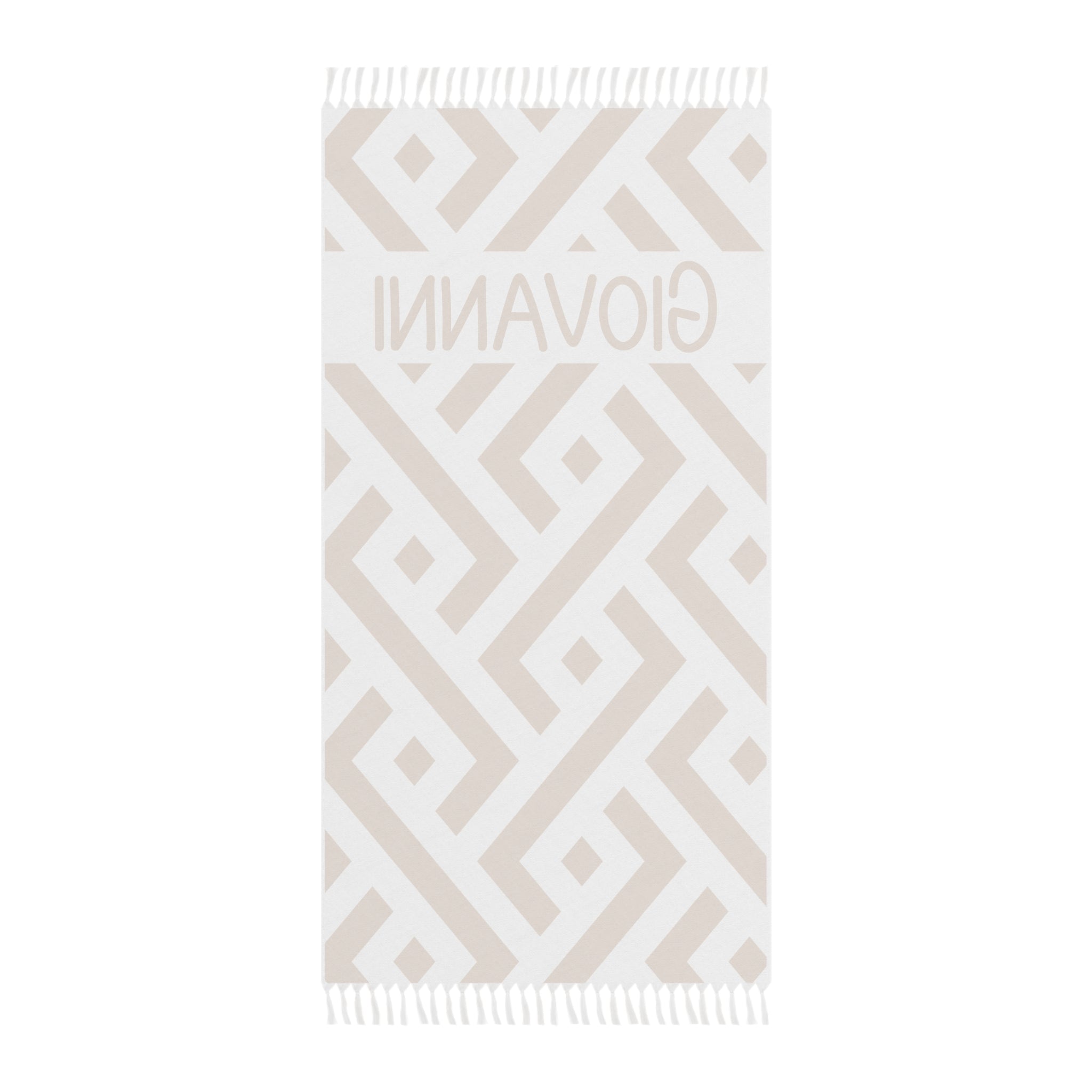 Personalized geometric beach towel laid flat with boho tassels