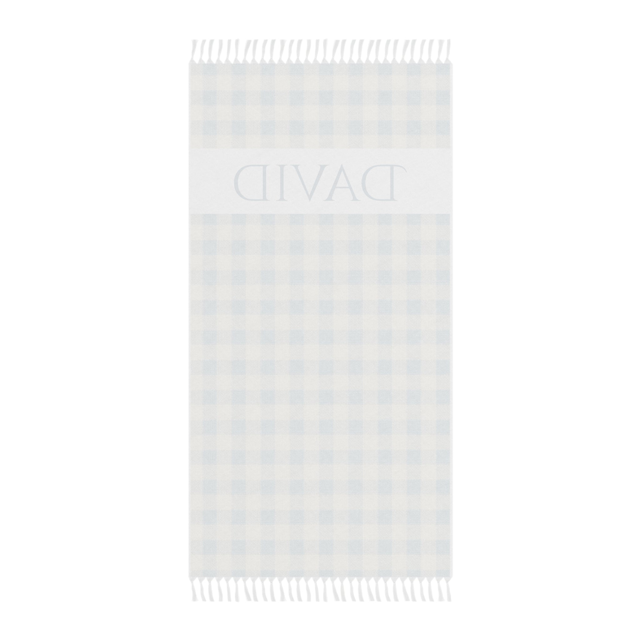 Personalized gingham beach towel laid flat with boho tassels