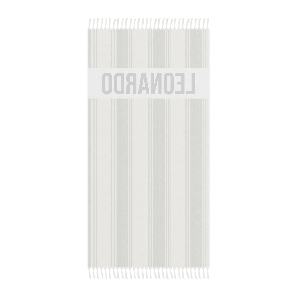 Personalized green stripe beach towel laid flat with boho tassels