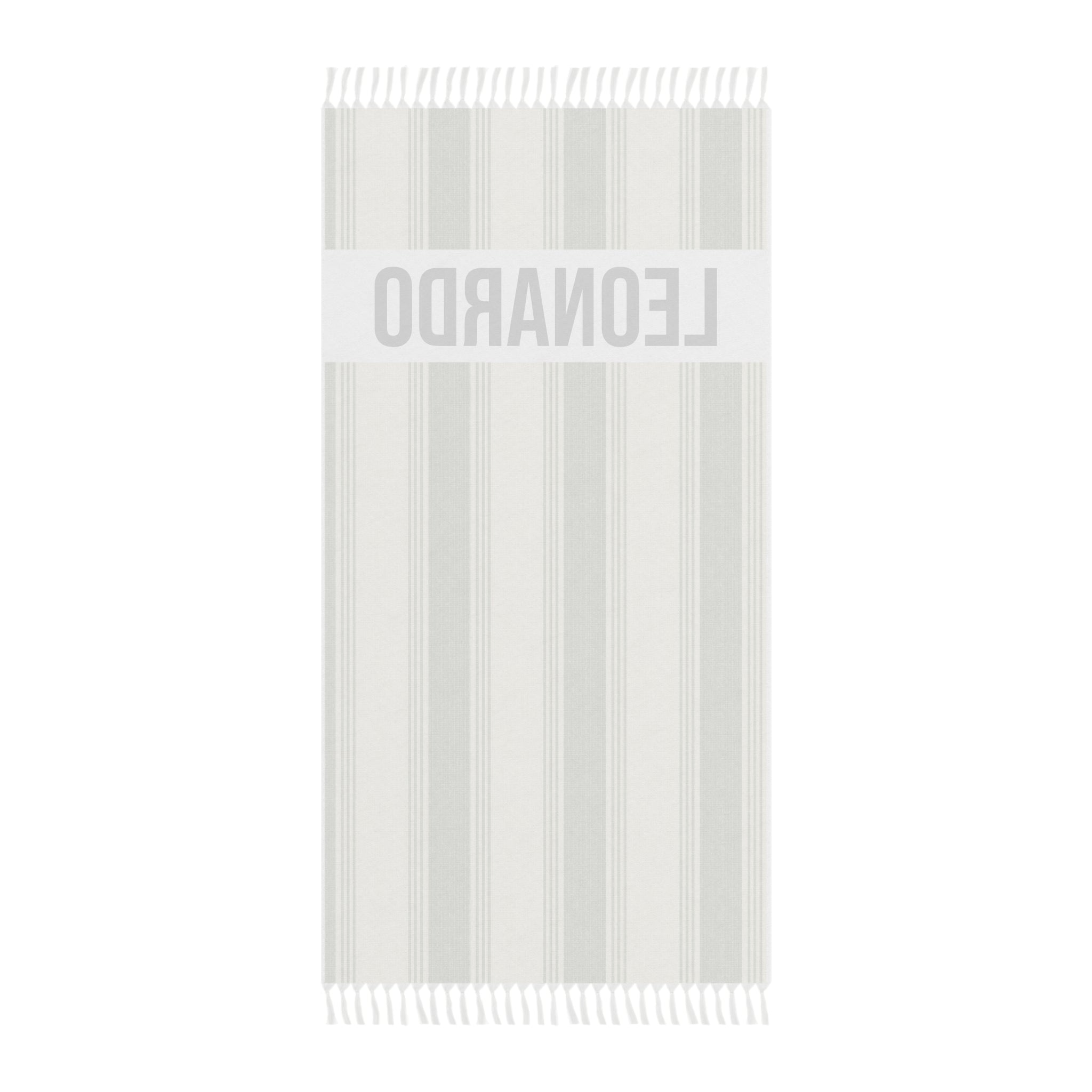 Personalized green stripe beach towel laid flat with boho tassels