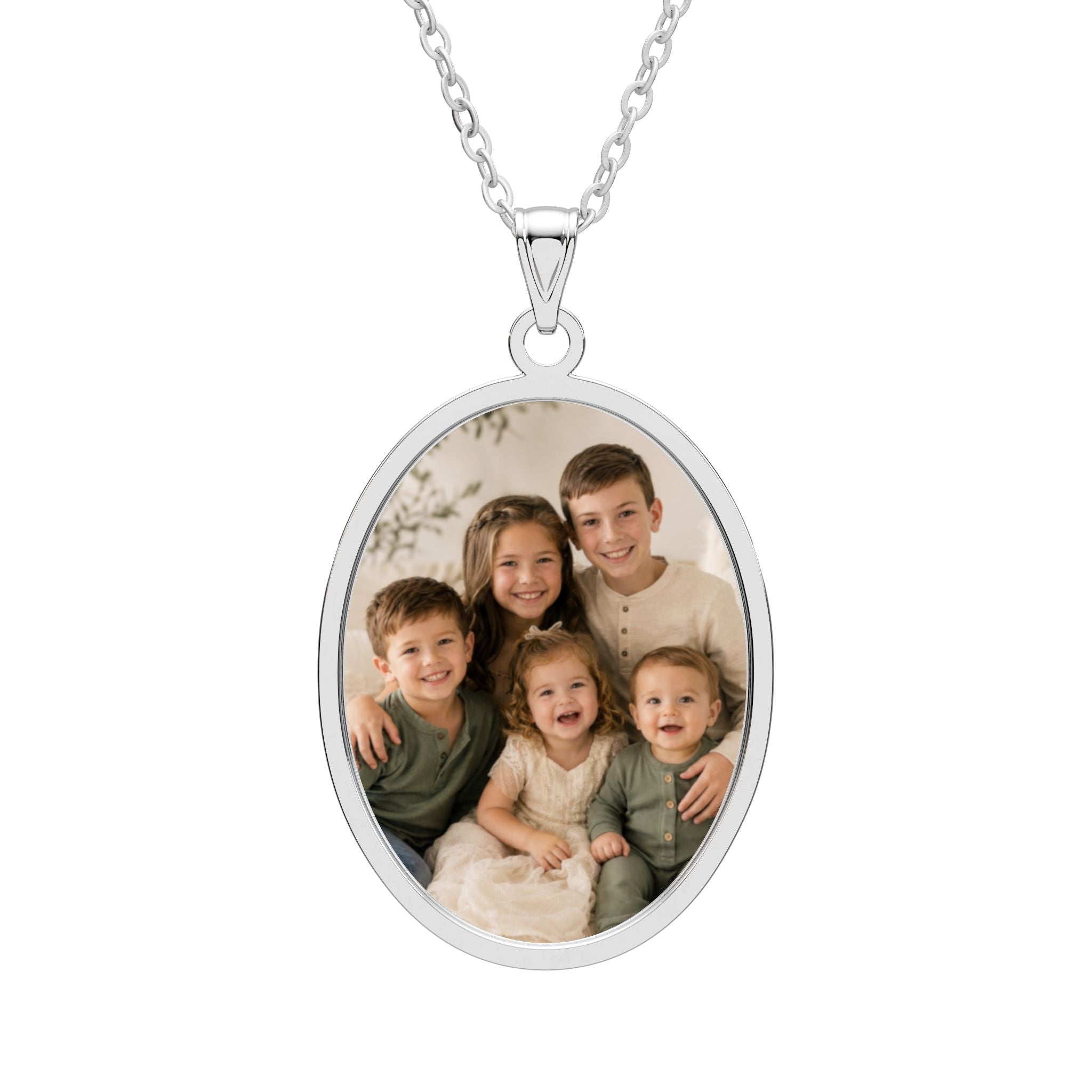 Personalized kids photo necklace in an oval sterling silver pendant with an engraved frame on a cable chain