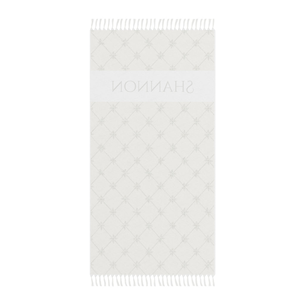 Personalized lattice beach towel laid flat with boho tassels