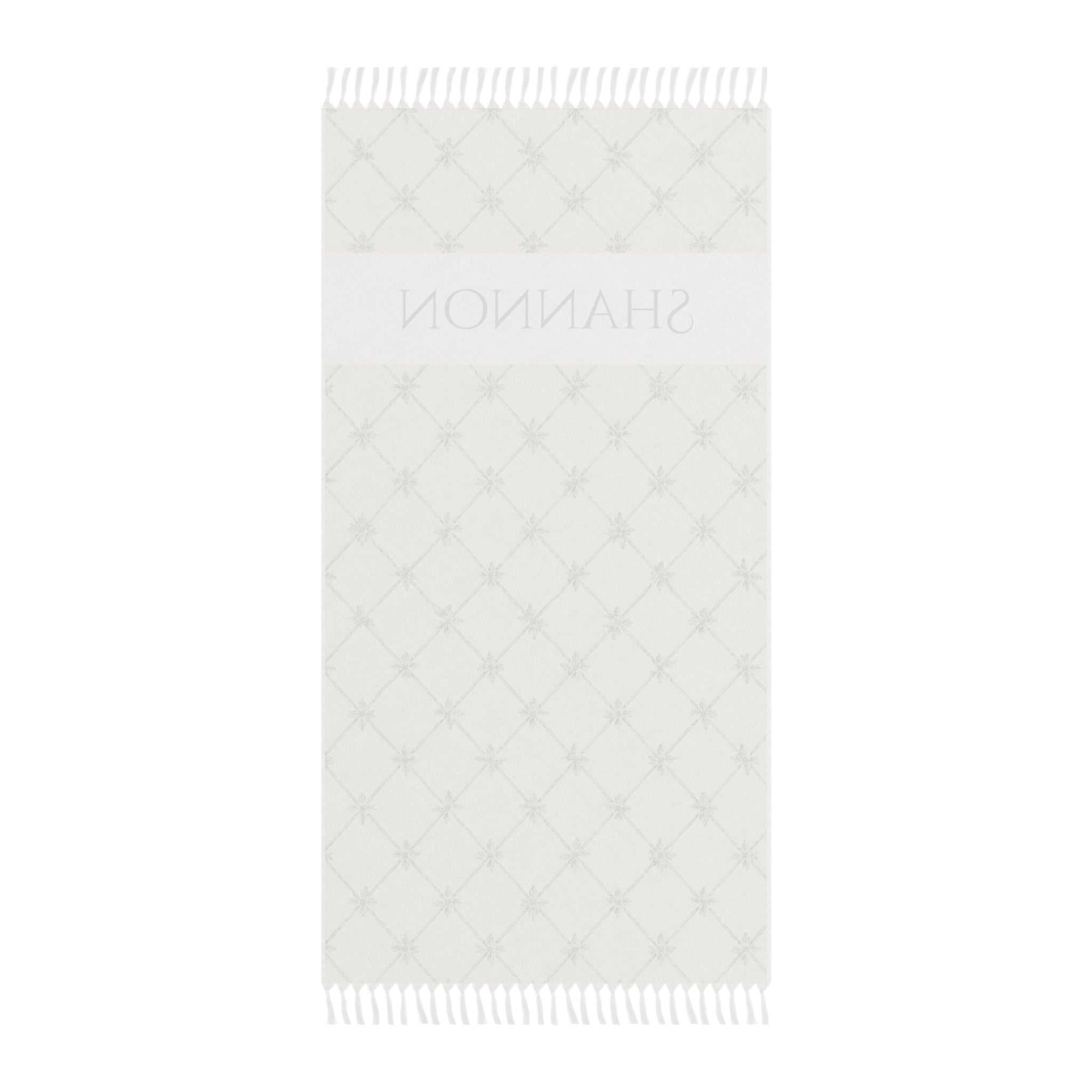 Personalized lattice beach towel laid flat with boho tassels