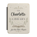Personalized library Kindle case in cream PU leather with laurels, an open book, and a custom name reading The Library