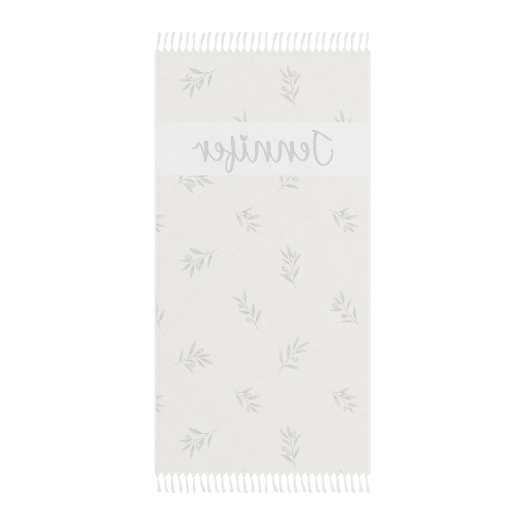 Personalized olive branch beach towel laid flat with boho tassels
