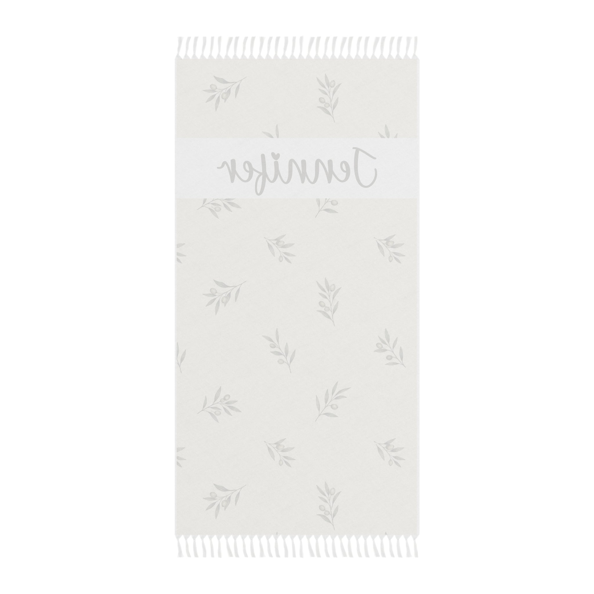 Personalized olive branch beach towel laid flat with boho tassels
