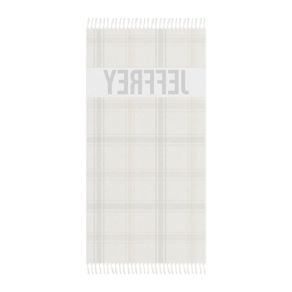 Personalized plaid beach towel laid flat with boho tassels