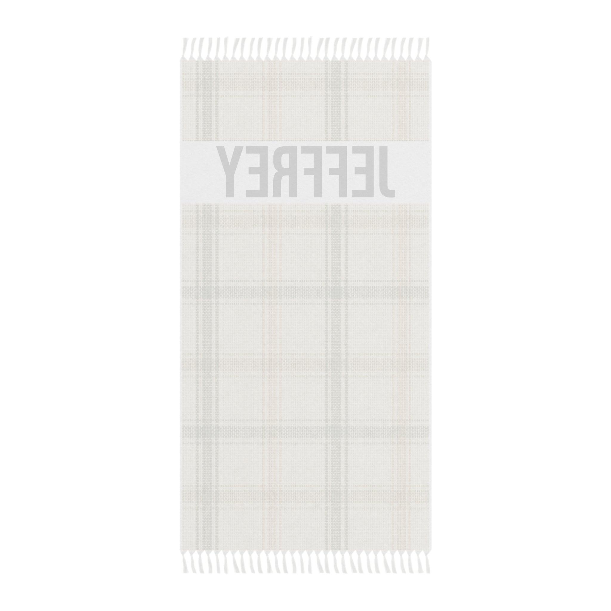 Personalized plaid beach towel laid flat with boho tassels
