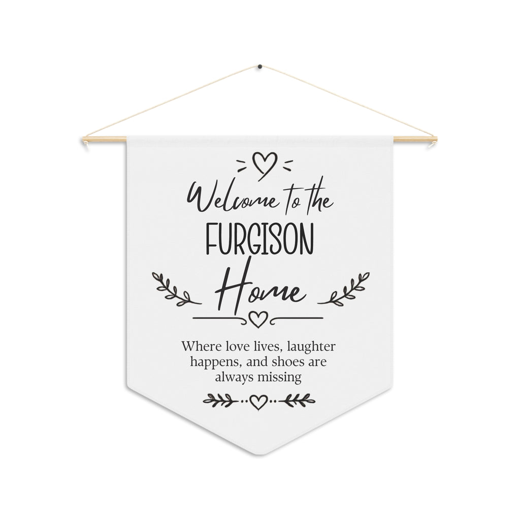 Personalized welcome home pennant with a family name and the words Where love lives, laughter happens, and shoes are always missing