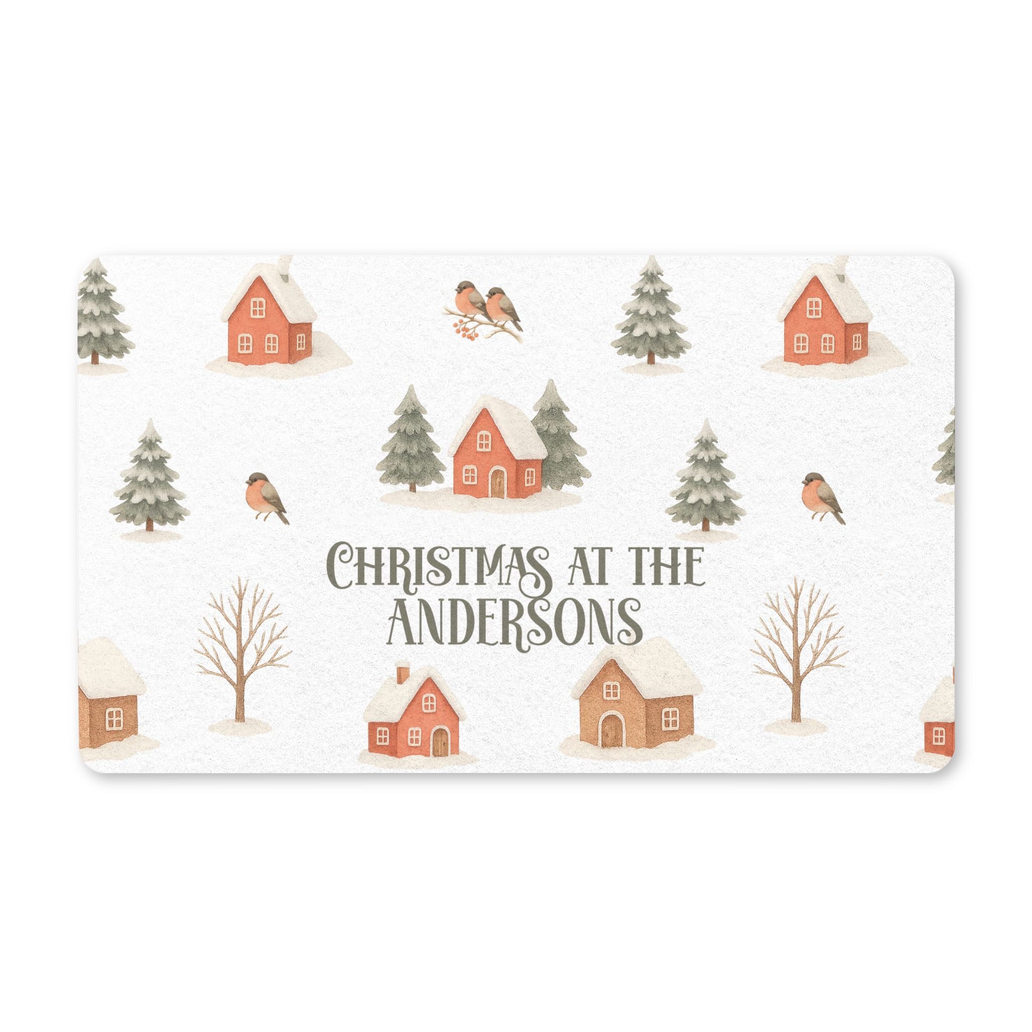 Personalized winter village Christmas doormat with a family name, cozy cottages, pine trees and robins on a snowy background