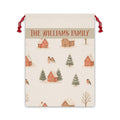 Personalized winter village Santa sack with a family name band, snowy cottages, pine trees and birds on a cream drawstring bag