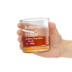 Hand holding a personalized 'Retirement Mode Activated' whiskey rocks glass with whiskey